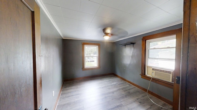 1219 Oakland St, Fort Wayne, IN 46808 - spare room featuring cooling unit, crown molding, and wood finished floors