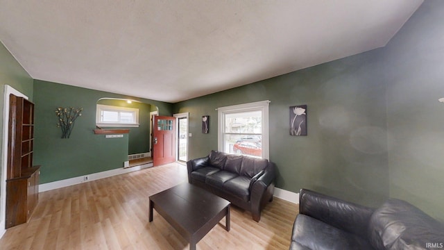 1219 Oakland St, Fort Wayne, IN 46808 - living room featuring wood finished floors, arched walkways, and healthy amount of natural light