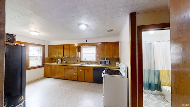 1219 Oakland St, Fort Wayne, IN 46808 - kitchen featuring black appliances, brown cabinets, and light countertops