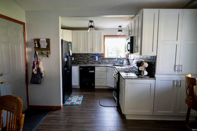 27222 Country Lake Ln, Elkhart, IN 46514 - kitchen with black appliances, decorative backsplash, dark wood-type flooring, stone countertops, and white cabinetry
