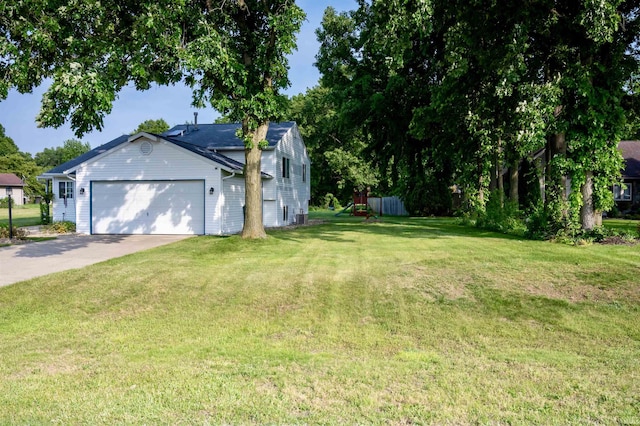 27222 Country Lake Ln, Elkhart, IN 46514 - view of grassy yard with an attached garage and concrete driveway