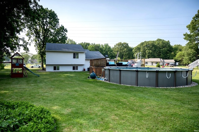 27222 Country Lake Ln, Elkhart, IN 46514 - view of green lawn with a playground and an outdoor pool