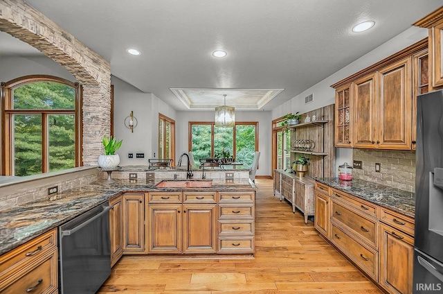 55623 Little Creek Ln, Middlebury, IN 46540 - kitchen with stainless steel dishwasher, light wood-style flooring, black refrigerator with ice dispenser, brown cabinetry, and recessed lighting