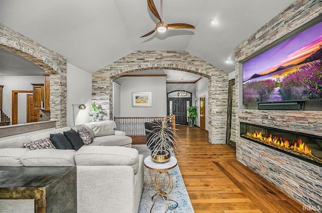55623 Little Creek Ln, Middlebury, IN 46540 - living room with ceiling fan, arched walkways, wood finished floors, a fireplace, and lofted ceiling