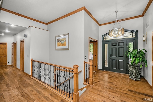 55623 Little Creek Ln, Middlebury, IN 46540 - entryway with light wood-style flooring, healthy amount of natural light, ornamental molding, and a chandelier