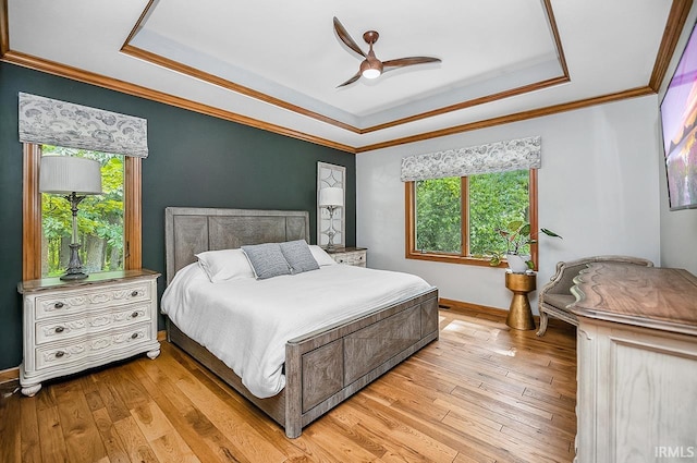 55623 Little Creek Ln, Middlebury, IN 46540 - bedroom featuring a raised ceiling, ornamental molding, light wood-type flooring, and a ceiling fan