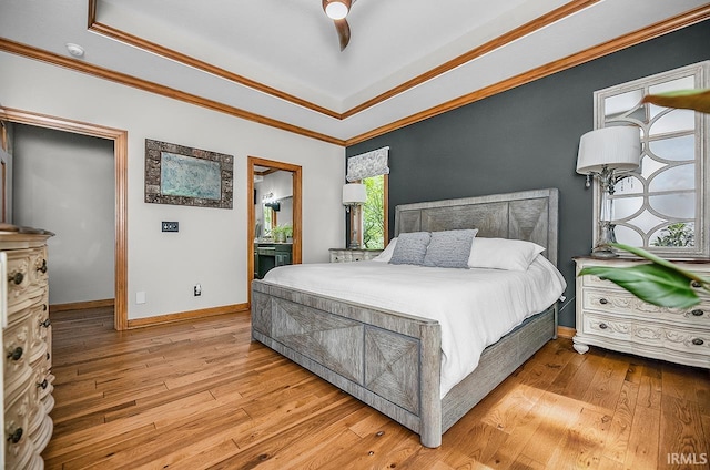 55623 Little Creek Ln, Middlebury, IN 46540 - bedroom featuring hardwood / wood-style floors, crown molding, a raised ceiling, ensuite bath, and ceiling fan