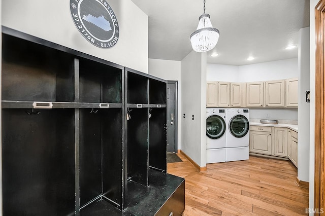 55623 Little Creek Ln, Middlebury, IN 46540 - laundry area featuring cabinet space, washing machine and clothes dryer, light wood-style floors, a chandelier, and recessed lighting