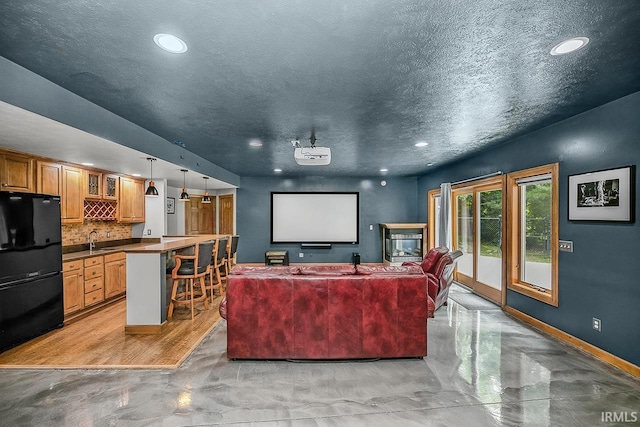 55623 Little Creek Ln, Middlebury, IN 46540 - cinema room with recessed lighting, bar, a textured ceiling, and concrete flooring