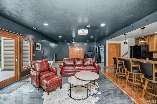 55623 Little Creek Ln, Middlebury, IN 46540 - living room with recessed lighting, finished concrete floors, washer / dryer, and a textured ceiling