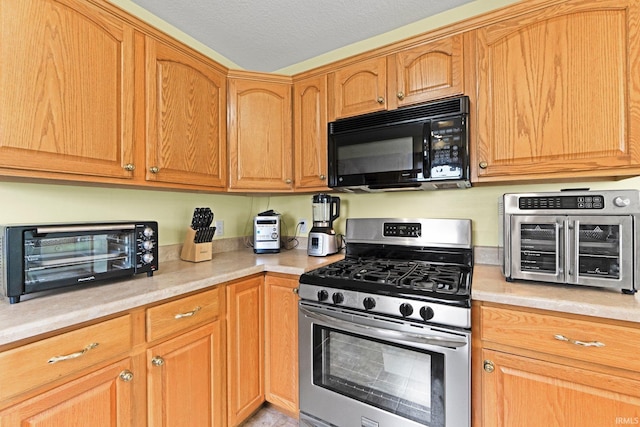 1108 Willen Ln, Fort Wayne, IN 46818 - kitchen with black microwave, stainless steel range with gas cooktop, and light countertops