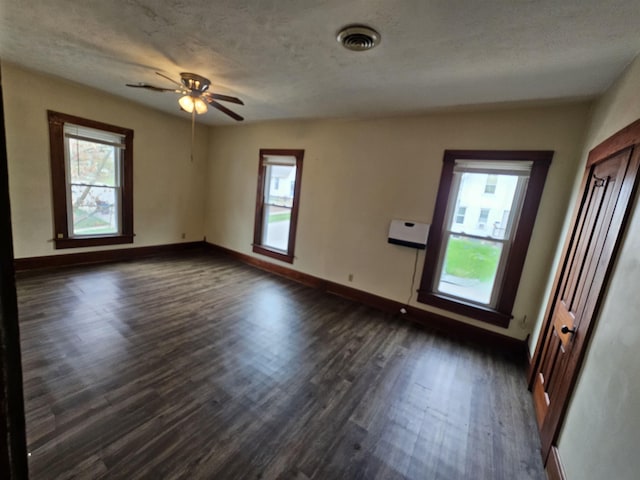 295-297 W Main St, Wabash, IN 46992 - empty room featuring healthy amount of natural light, dark wood-style floors, ceiling fan, and a textured ceiling
