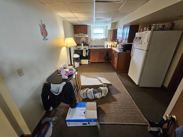 295-297 W Main St, Wabash, IN 46992 - kitchen featuring freestanding refrigerator, a paneled ceiling, dark carpet, and brown cabinetry