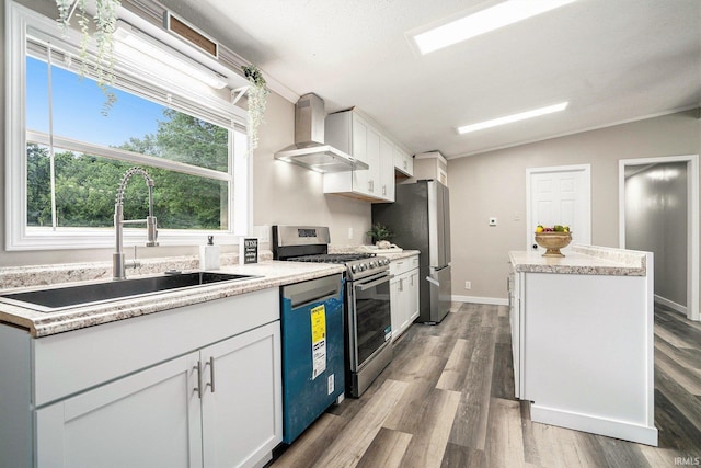 17725 Douglas Rd, South Bend, IN 46635 - kitchen with wall chimney exhaust hood, appliances with stainless steel finishes, a center island, light wood-style floors, and lofted ceiling