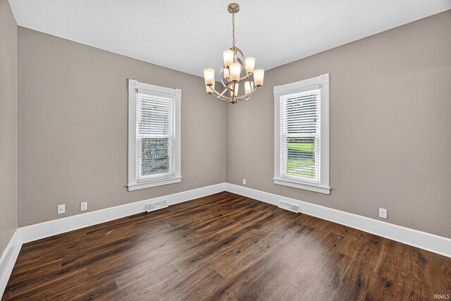119 Towle Ave, Mishawaka, IN 46544 - unfurnished room with plenty of natural light, a chandelier, and dark wood-type flooring