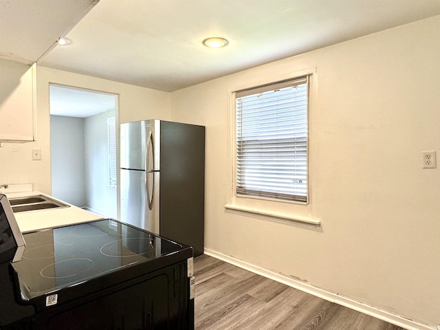 1106 W Rose St, South Bend, IN 46616 - kitchen featuring black electric range, light wood finished floors, freestanding refrigerator, and recessed lighting