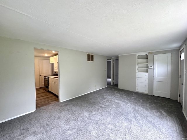 1106 W Rose St, South Bend, IN 46616 - unfurnished bedroom featuring dark colored carpet, a textured ceiling, and connected bathroom