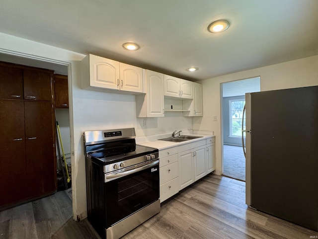 1106 W Rose St, South Bend, IN 46616 - kitchen with stainless steel appliances, wood finished floors, white cabinetry, light countertops, and recessed lighting