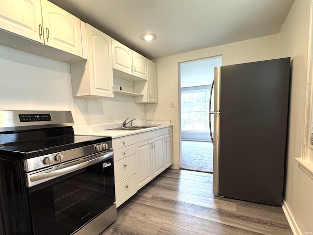 1106 W Rose St, South Bend, IN 46616 - kitchen with stainless steel appliances, dark wood-type flooring, light countertops, white cabinets, and recessed lighting