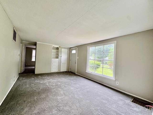 1106 W Rose St, South Bend, IN 46616 - unfurnished living room featuring a textured ceiling and carpet floors