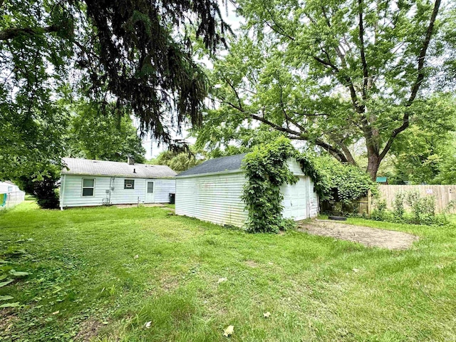 1106 W Rose St, South Bend, IN 46616 - view of yard with an outbuilding, a garage, and driveway