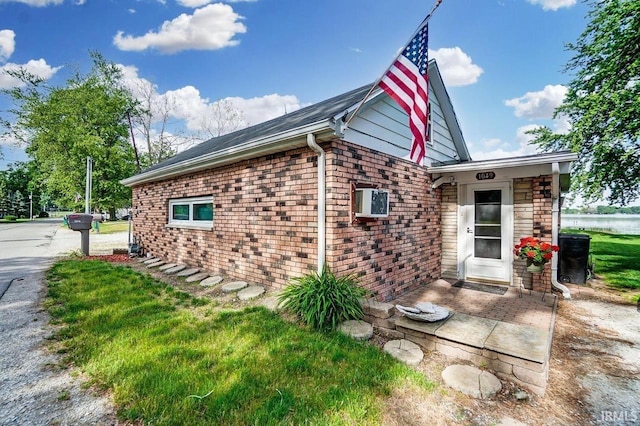 1049 Chapman Lake Dr, Warsaw, IN 46582 - view of property exterior with brick siding and a lawn