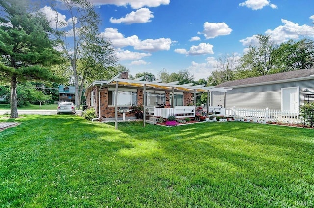 1049 Chapman Lake Dr, Warsaw, IN 46582 - view of front facade with a pergola, a chimney, a front yard, brick siding, and a wooden deck