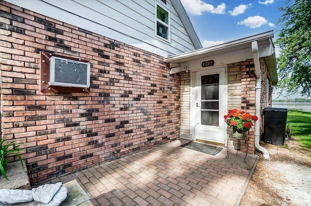 1049 Chapman Lake Dr, Warsaw, IN 46582 - doorway to property featuring brick siding and a patio area