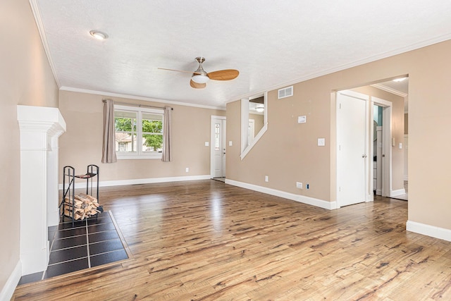 51268 Channel Ct, Elkhart, IN 46514 - unfurnished living room featuring a ceiling fan, crown molding, wood finished floors, and a textured ceiling