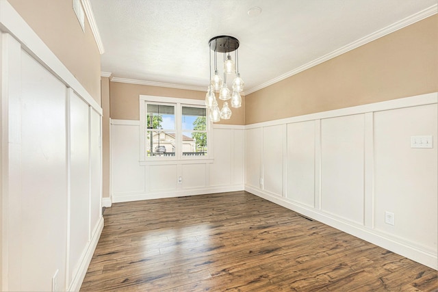51268 Channel Ct, Elkhart, IN 46514 - unfurnished dining area featuring a decorative wall, dark wood-style flooring, ornamental molding, a chandelier, and wainscoting