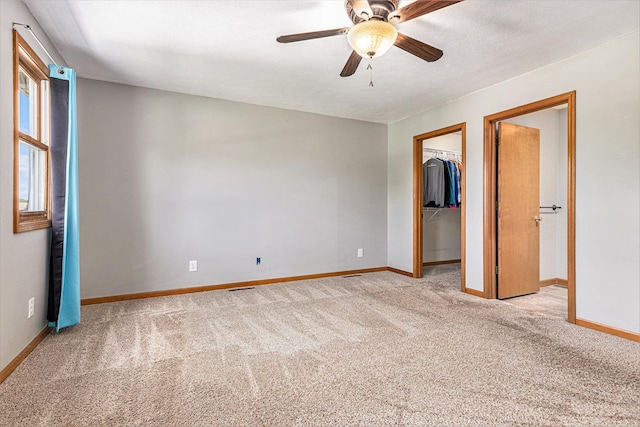 51268 Channel Ct, Elkhart, IN 46514 - unfurnished bedroom with carpet flooring, a spacious closet, a closet, and ceiling fan