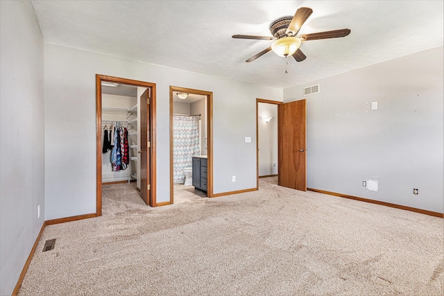 51268 Channel Ct, Elkhart, IN 46514 - unfurnished bedroom with light colored carpet, a spacious closet, a closet, ensuite bathroom, and ceiling fan