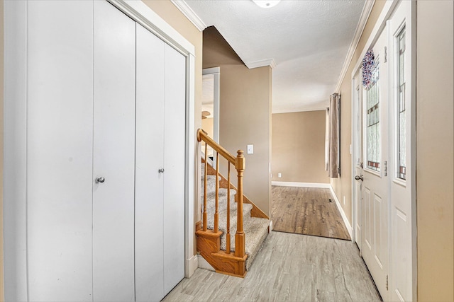 51268 Channel Ct, Elkhart, IN 46514 - foyer entrance featuring light wood finished floors, crown molding, and stairway