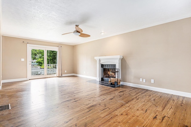 51268 Channel Ct, Elkhart, IN 46514 - unfurnished living room featuring a ceiling fan, a fireplace with flush hearth, wood finished floors, and crown molding