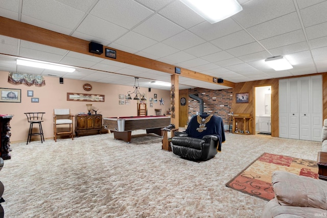 16123 County Road 18, Goshen, IN 46528 - carpeted living room with a wood stove, a drop ceiling, wooden walls, and billiards