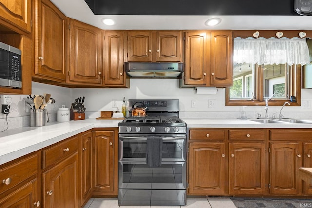 16123 County Road 18, Goshen, IN 46528 - kitchen featuring stainless steel appliances, under cabinet range hood, and brown cabinets