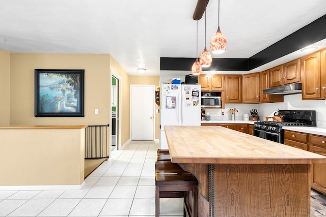 16123 County Road 18, Goshen, IN 46528 - kitchen featuring gas stove, under cabinet range hood, light tile patterned floors, butcher block countertops, and freestanding refrigerator
