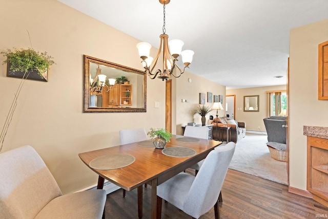 1123 E Gump Rd, Fort Wayne, IN 46845 - dining area featuring a chandelier, dark wood finished floors, and a baseboard radiator