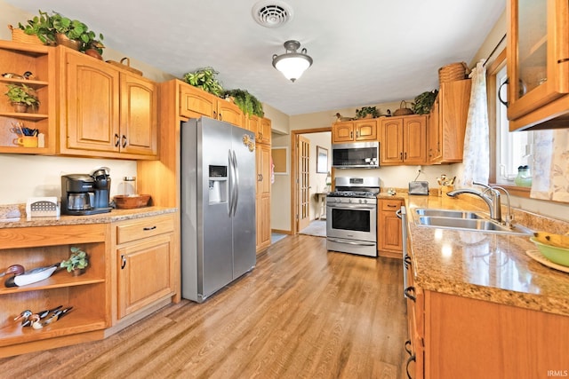 1123 E Gump Rd, Fort Wayne, IN 46845 - kitchen featuring appliances with stainless steel finishes, open shelves, light wood-style flooring, and glass insert cabinets