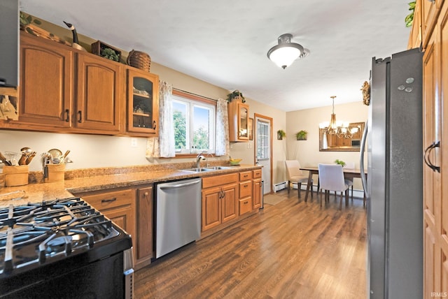1123 E Gump Rd, Fort Wayne, IN 46845 - kitchen with appliances with stainless steel finishes, dark wood finished floors, a chandelier, and brown cabinets