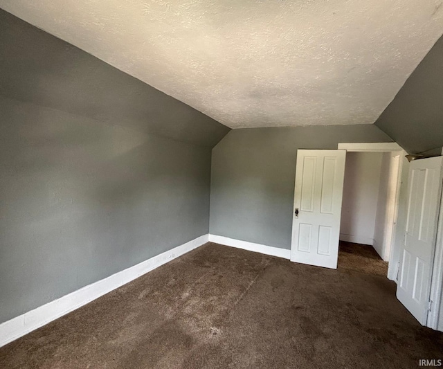 2307 Linden Ave, South Bend, IN 46628 - bonus room with vaulted ceiling, a textured ceiling, and dark colored carpet