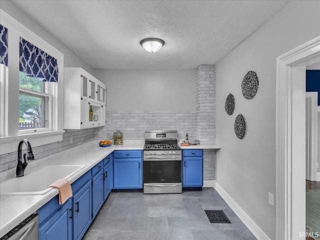 1310 W Jefferson Blvd, Fort Wayne, IN 46802 - kitchen featuring stainless steel appliances, blue cabinetry, backsplash, and a textured ceiling