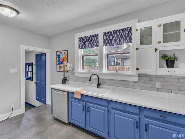 1310 W Jefferson Blvd, Fort Wayne, IN 46802 - kitchen featuring stainless steel dishwasher, blue cabinets, tasteful backsplash, a textured ceiling, and light countertops