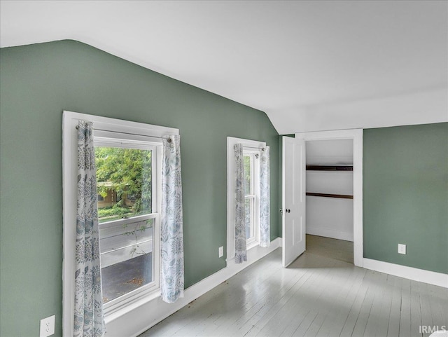 1310 W Jefferson Blvd, Fort Wayne, IN 46802 - unfurnished bedroom with vaulted ceiling and wood-type flooring