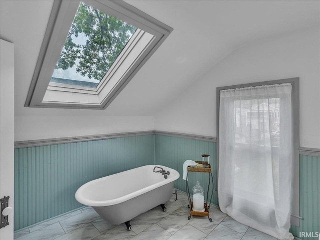 1310 W Jefferson Blvd, Fort Wayne, IN 46802 - bathroom with marble finish floors, lofted ceiling, a freestanding tub, plenty of natural light, and a wainscoted wall