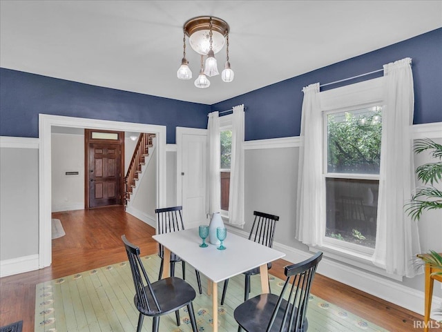 1310 W Jefferson Blvd, Fort Wayne, IN 46802 - dining room featuring wood-type flooring, stairway, and a chandelier