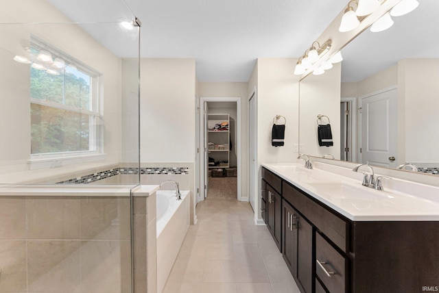 1114 Mosaic St, Huntertown, IN 46748 - full bathroom featuring a bath, double vanity, tile patterned flooring, and a walk in closet