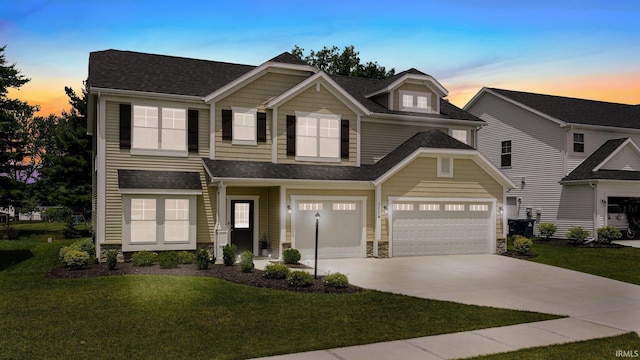 1114 Mosaic St, Huntertown, IN 46748 - view of front facade with concrete driveway, a yard, stone siding, a shingled roof, and an attached garage