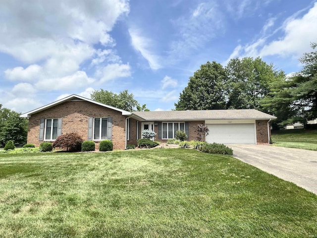 1140 Carlisle Dr, Jasper, IN 47546 - ranch-style home featuring brick siding, an attached garage, driveway, and a front yard