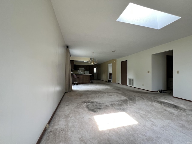 1140 Carlisle Dr, Jasper, IN 47546 - unfurnished living room featuring a skylight, a chandelier, and light carpet